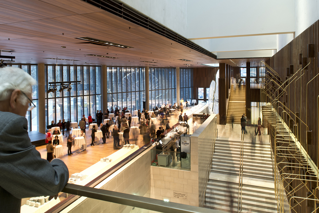 Linz Music Theatre foyer illuminated by ERCO lighting for cultural events.
