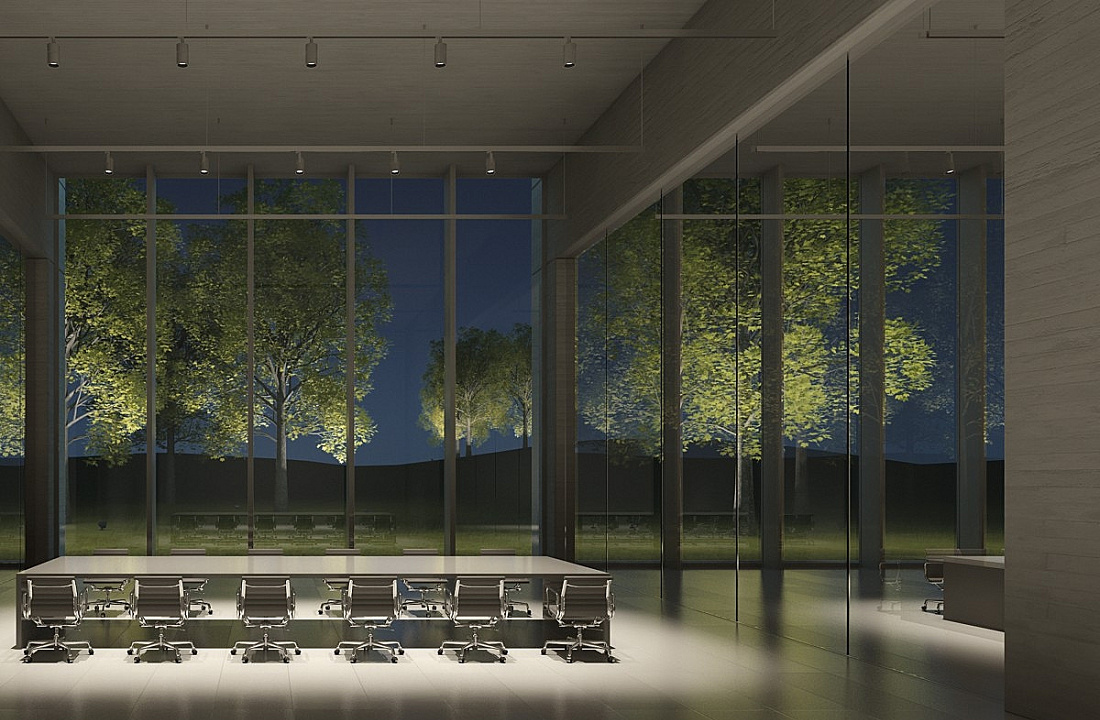 Conference room with ERCO lighting and a view through the glass facade onto illuminated trees.