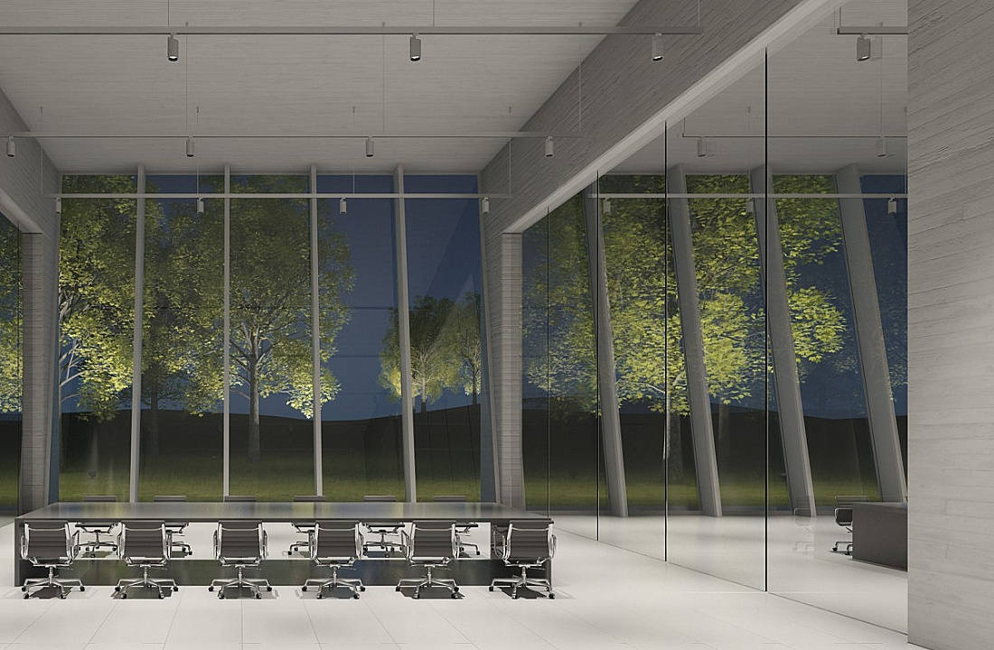 Conference room with ERCO lighting and a view through the glass facade onto trees outside.