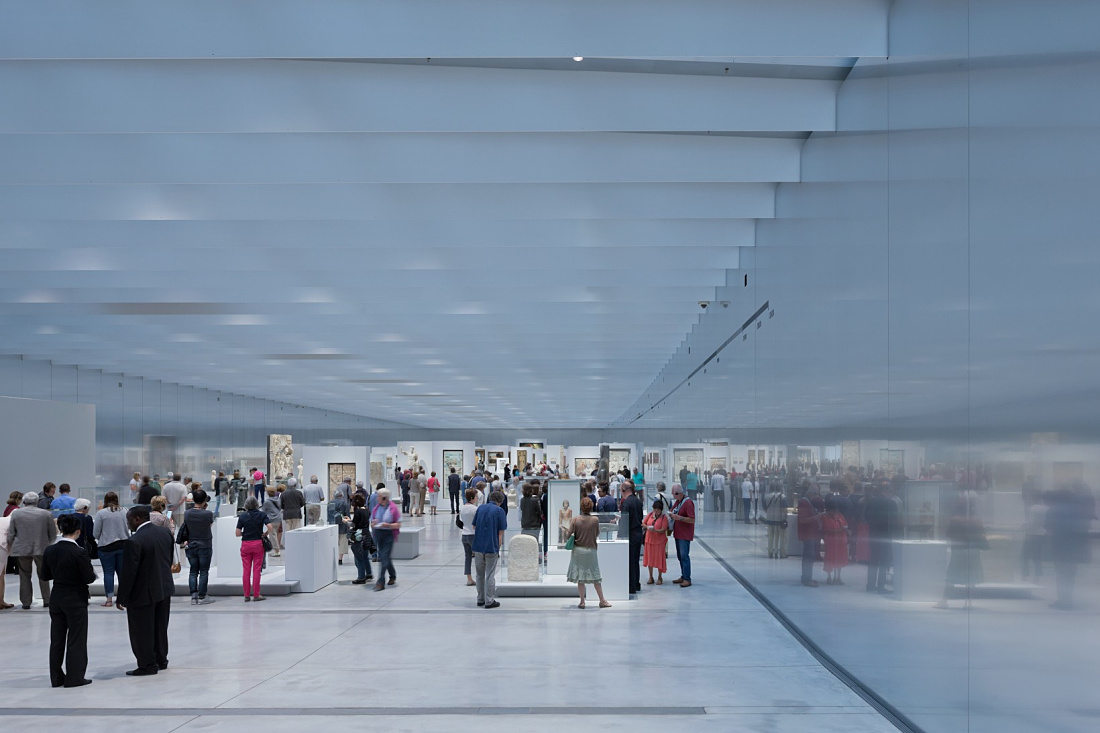 Interior of the Louvre Lens Museum featuring visitors and ERCO LED lighting.
