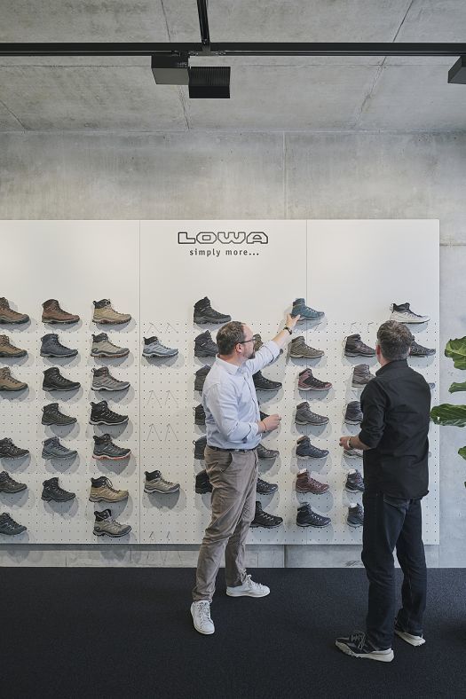 Lowa shoe display with ERCO lighting for optimal product presentation in office and showroom.