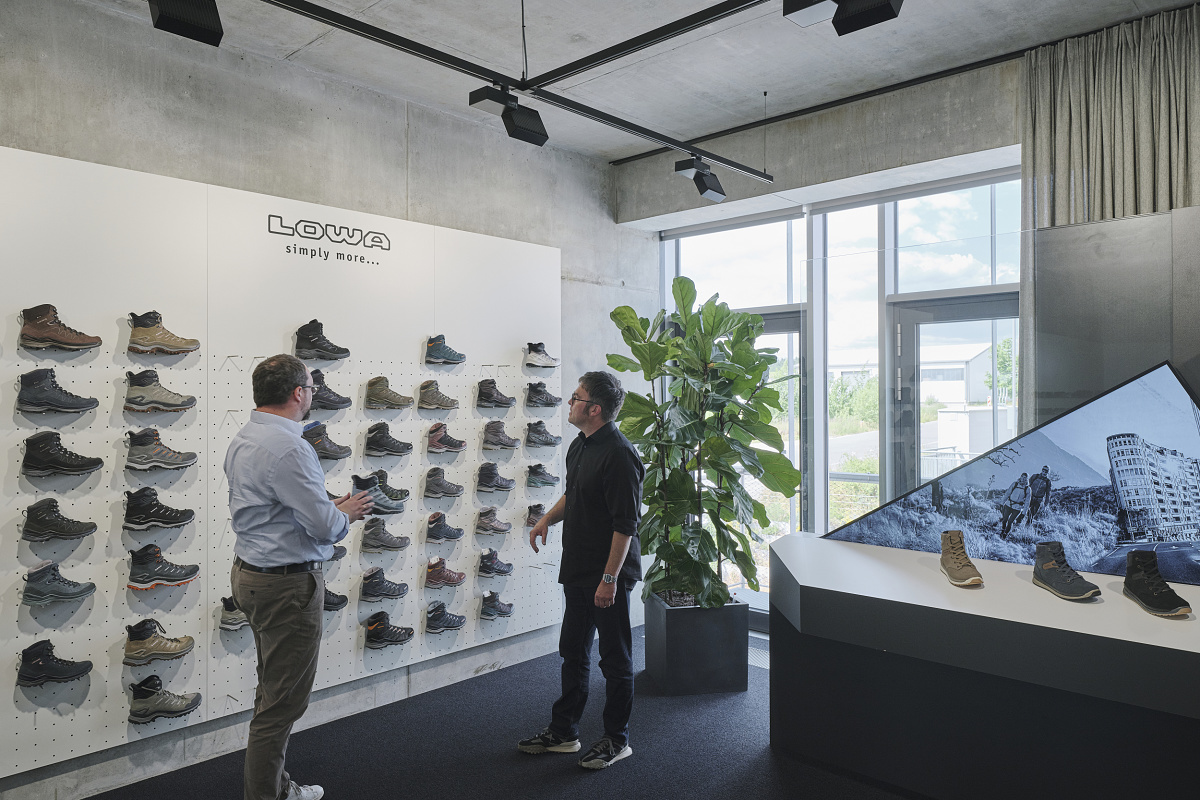 Lowa shoe display with ERCO office lighting, showcasing flexible, demand-oriented light solutions in the showroom.