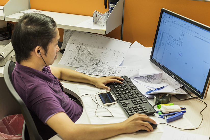 LuxLight employee planning lighting in the office with ERCO LED lights.
