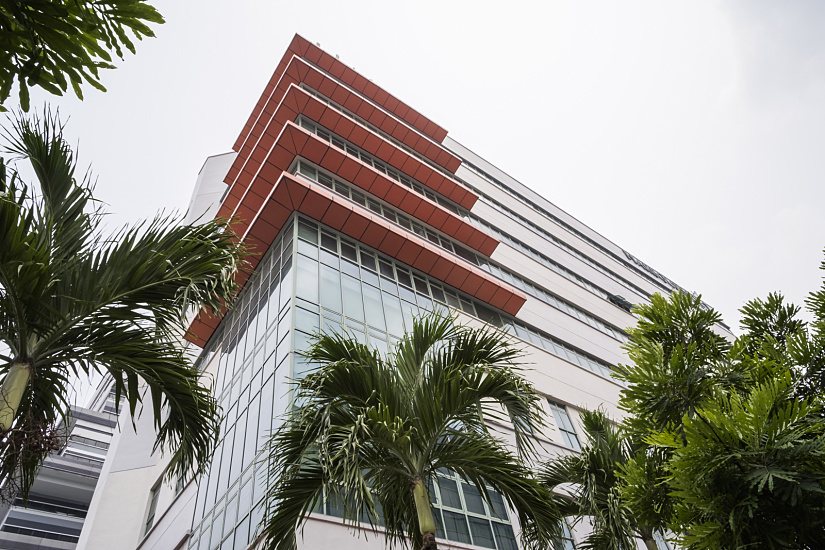 LuxLight office building in Singapore featuring ERCO LED lighting enhancing the orange facade.