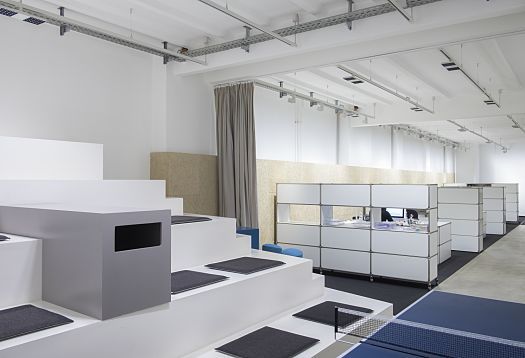 Modern loft office of mai public relations in Berlin featuring ERCO Jilly downlights for flexible lighting.