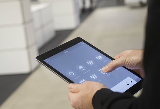 Tablet controlling ERCO Jilly downlights for flexible office lighting.