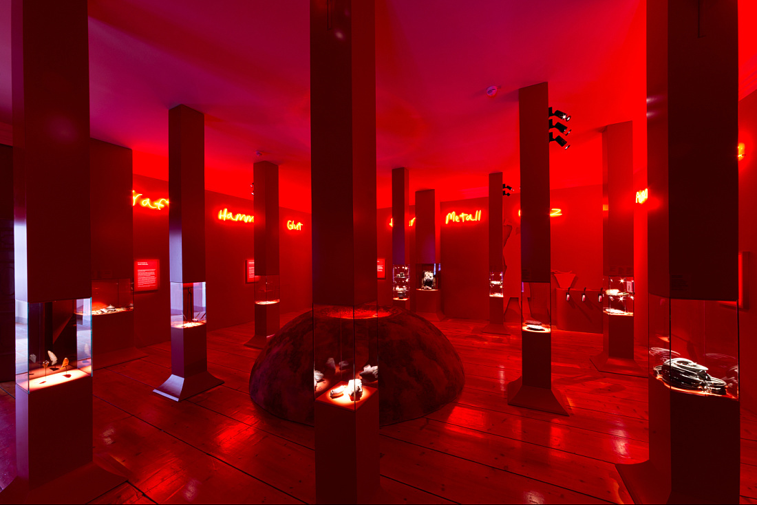 MAMUZ Museum Mistelbach exhibit illuminated by ERCO lighting, highlighting artifacts in red.