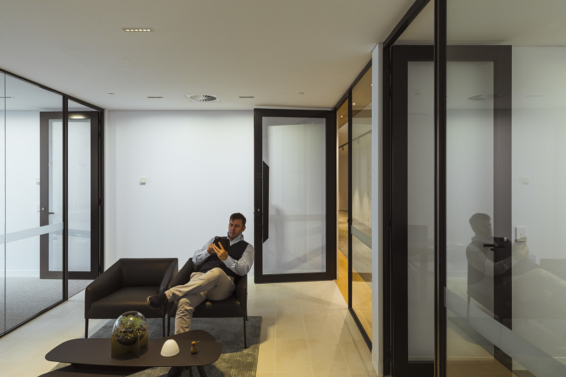 Modern office space featuring ERCO lighting for visual comfort and minimalist design.