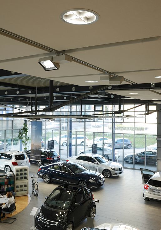 Mercedes showroom in Lugano featuring ERCO LED lighting for accentuating car displays.