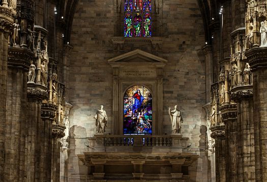 Interior of Milan Cathedral featuring ERCO LED lighting, highlighting details.