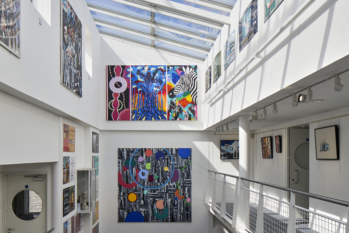 Millfield School art gallery featuring ERCO LED lighting and colorful artwork.