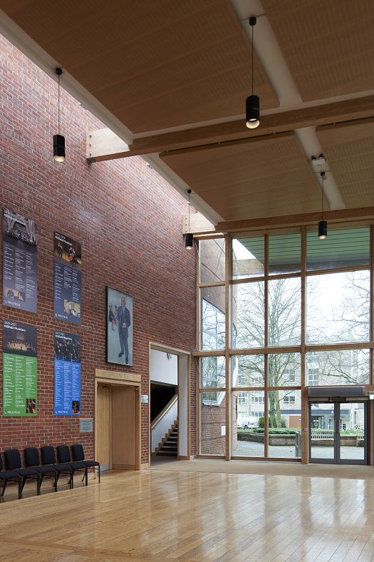 Millfield Schools concert hall featuring ERCO Atrium pendant luminaires for energy-efficient LED lighting.
