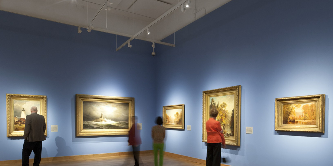Visitors view maritime art illuminated by ERCO Optec spotlights at the Minnesota Marine Art Museum.