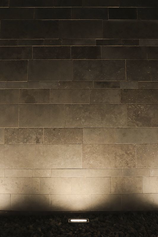 ERCO Site in-ground luminaire illuminating a stone wall at Missouri Botanical Garden.