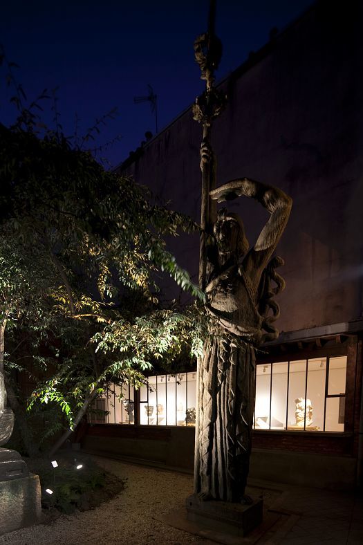 Illuminated Bourdelle sculpture in the Musée Bourdelle garden, Paris, at night.