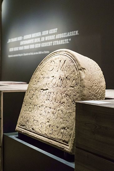 Roman gravestone at Hamburg History Museum, highlighted with ERCO accent lighting.