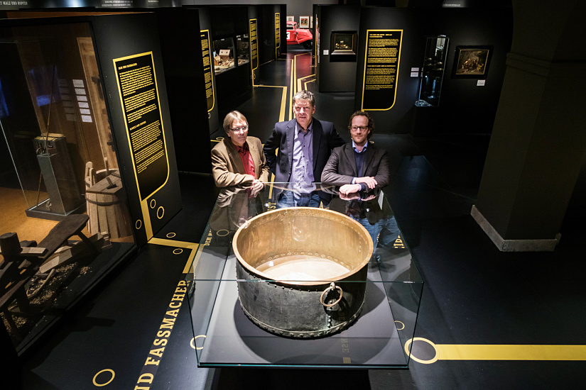 Brewing culture exhibit at Hamburg Museum featuring ERCO accent lighting on a historic brewing kettle.