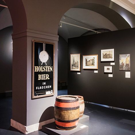 Holsten Beer ad and beer barrels at the Hamburg History Museum, lit with ERCO accent lighting.