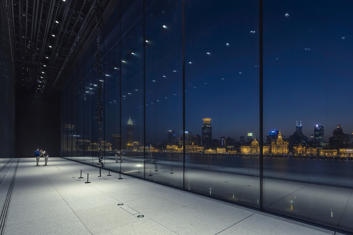 Museum of Art Pudong, Shanghai, featuring ERCO LED lighting and a view of the skyline at night.
