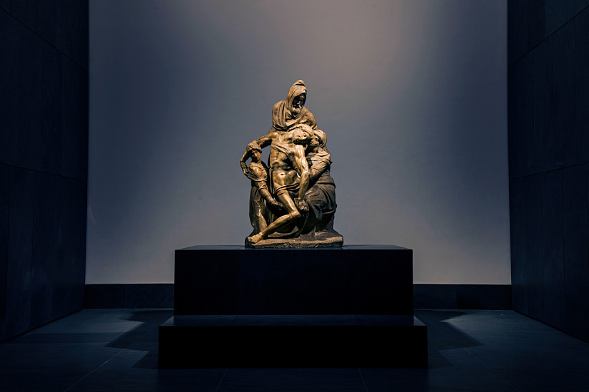 Michelangelo's Pietà Bandini sculpture, illuminated at the Florence Cathedral museum.