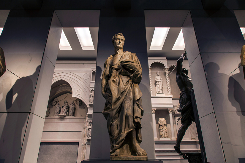 Sculpture in Florence Cathedral Museum, lit by ERCO LED spotlights, part of art exhibit.