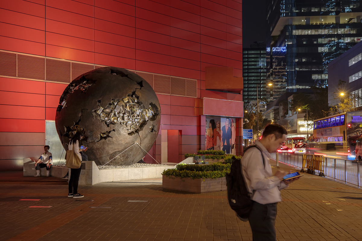 Illuminated sphere sculpture outside a museum, creating cultural experiences.