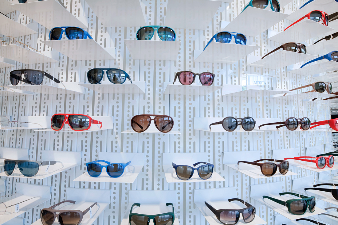 MYKITA sunglasses displayed on a wall in a shop, illuminated by ERCO LED spotlights.