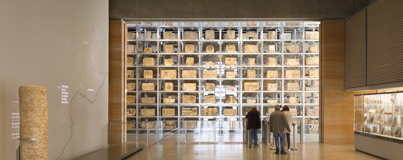 Narbo Via Museum's Lapidary Wall, illuminated by ERCO Optec spotlights, showcasing ancient Roman stones.