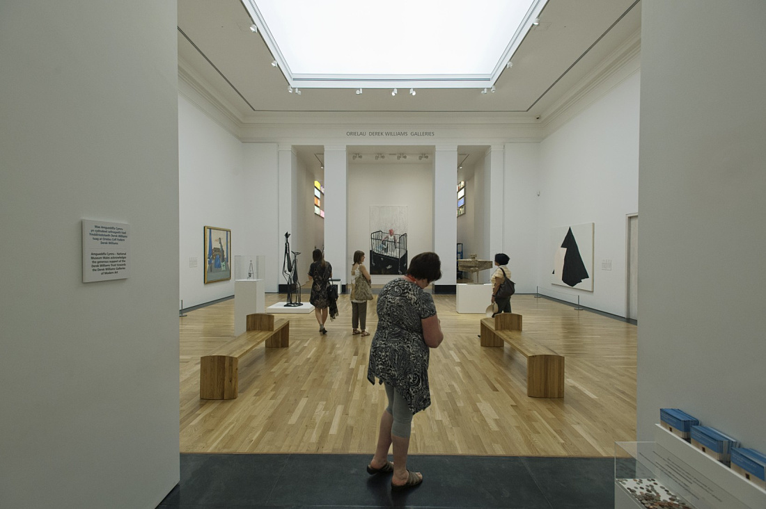 Interior of the National Museum Wales featuring ERCO LED lighting and visitors viewing artwork.
