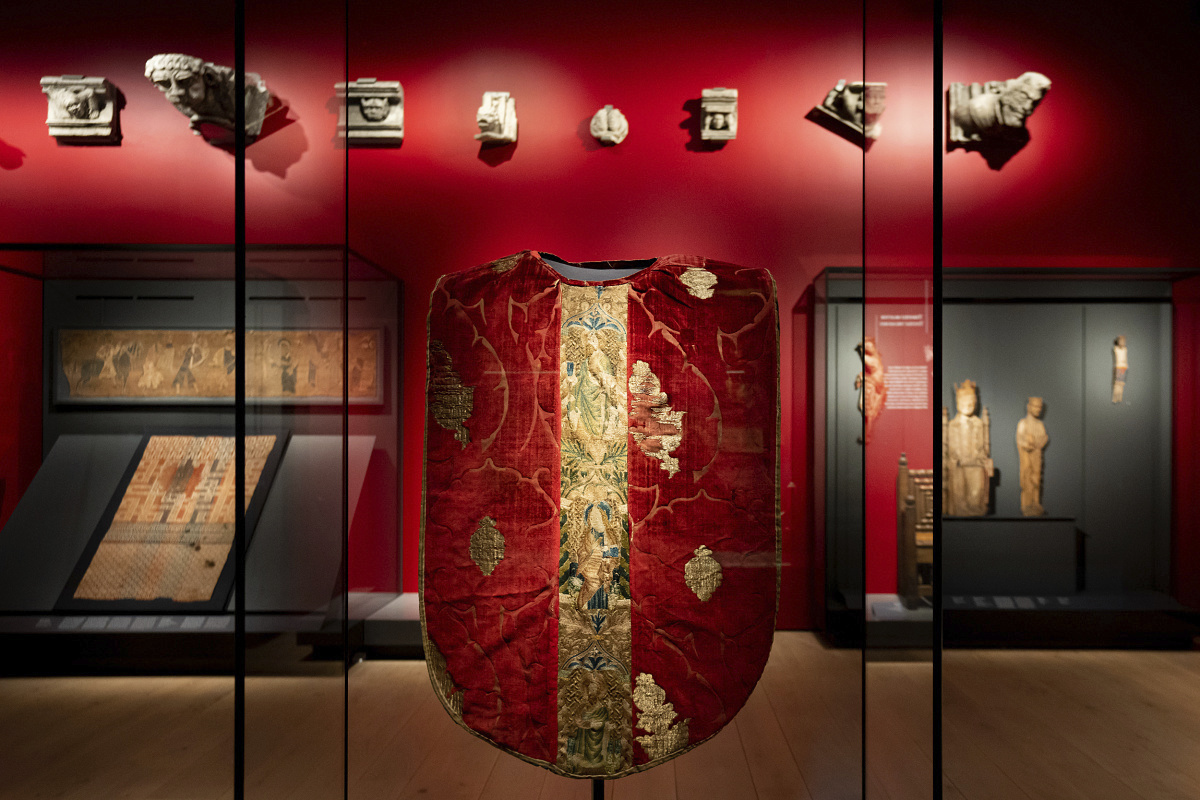 Embroidered red chasuble in an ERCO-lit exhibit at the National Museum Oslo.