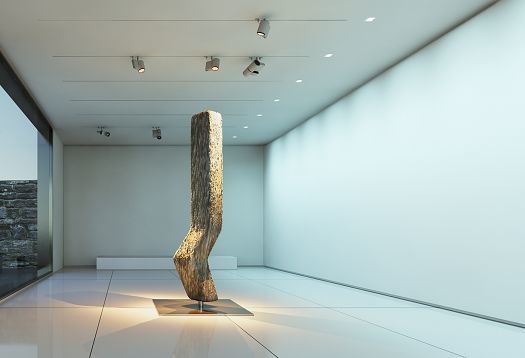 Illuminated wood sculpture in an exhibition space, accented by directed light from ERCO spotlights.
