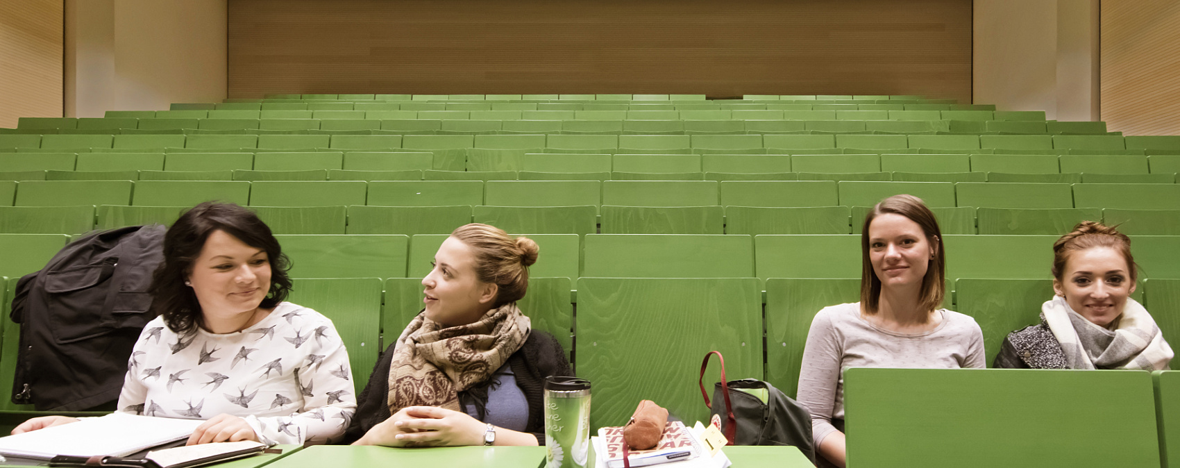 Students in the Neubrandenburg University auditorium, featuring ERCO downlights for efficient lighting.