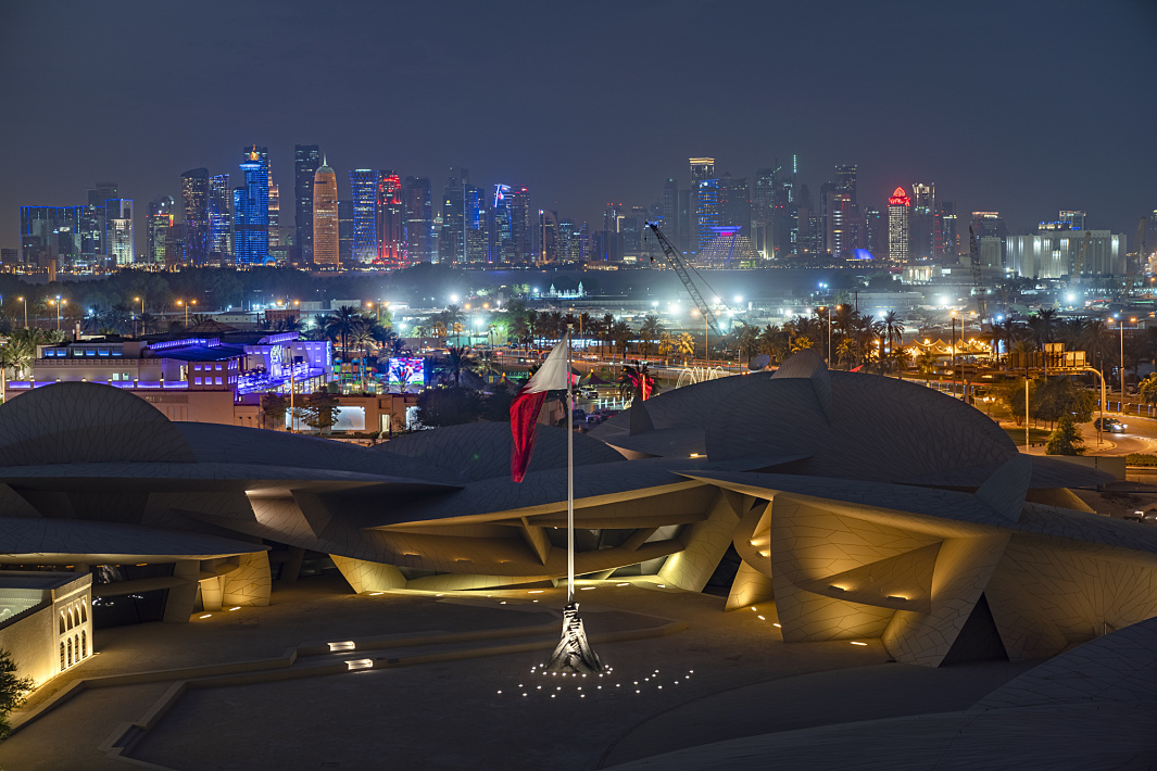 National Museum of Qatar illuminated by ERCO, showcasing the Doha skyline.