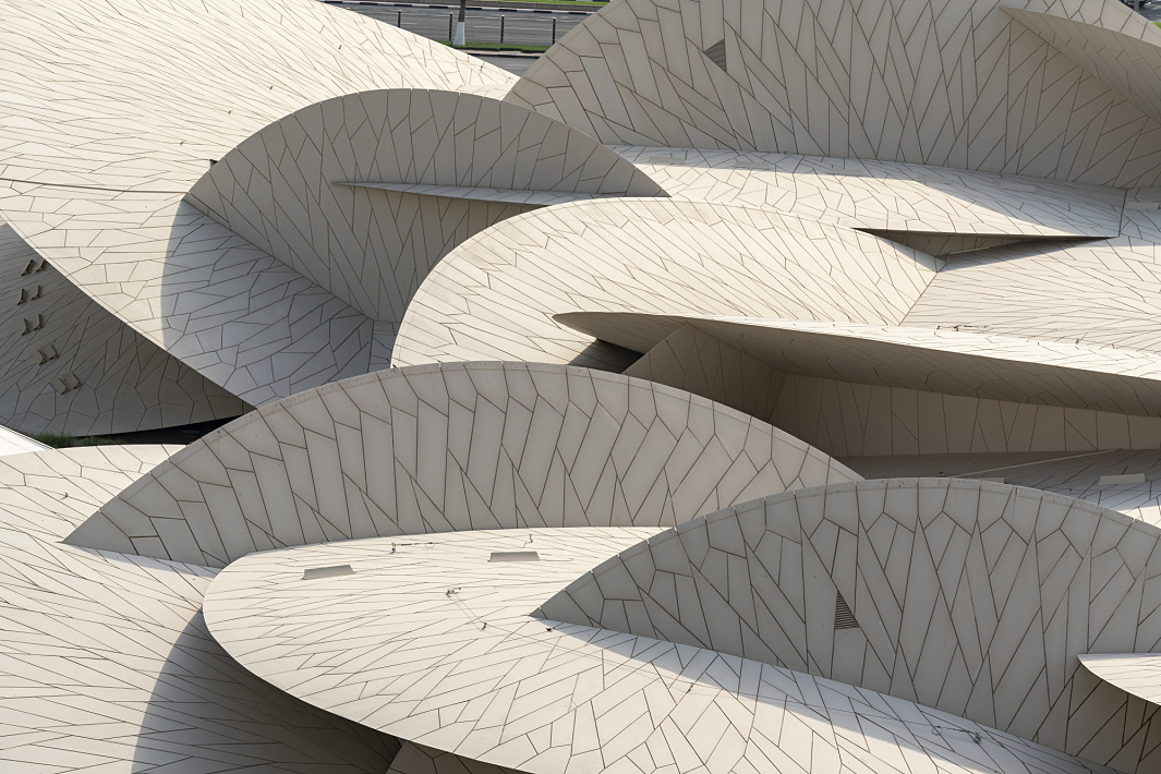 Close-up of the National Museum of Qatar, illuminated by ERCO lighting.