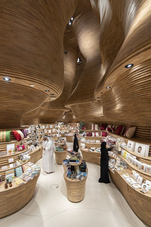 Interior of the National Museum of Qatar featuring undulating walls and ERCO lighting.