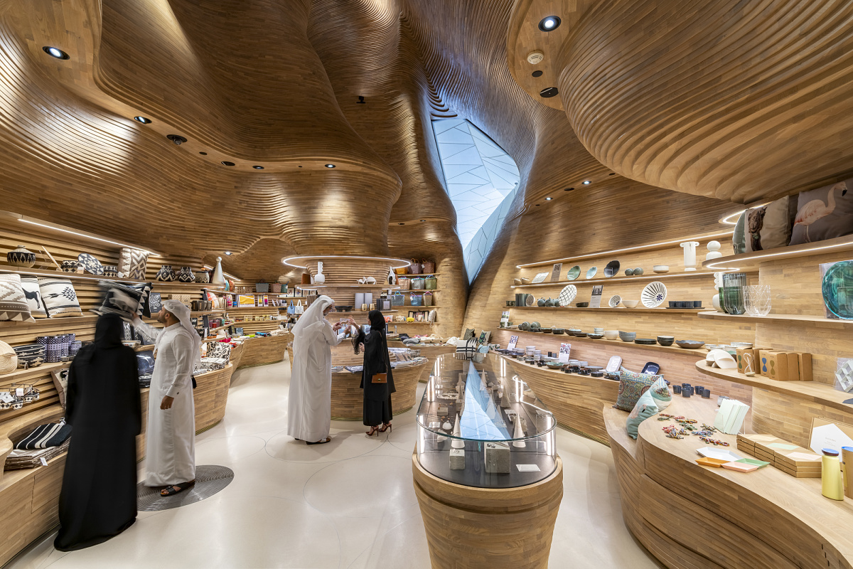 National Museum of Qatar shop featuring ERCO lighting and undulating walls.