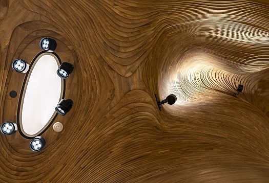 ERCO LED lighting in the National Museum of Qatars organic ceiling, creating a cave-like ambiance.