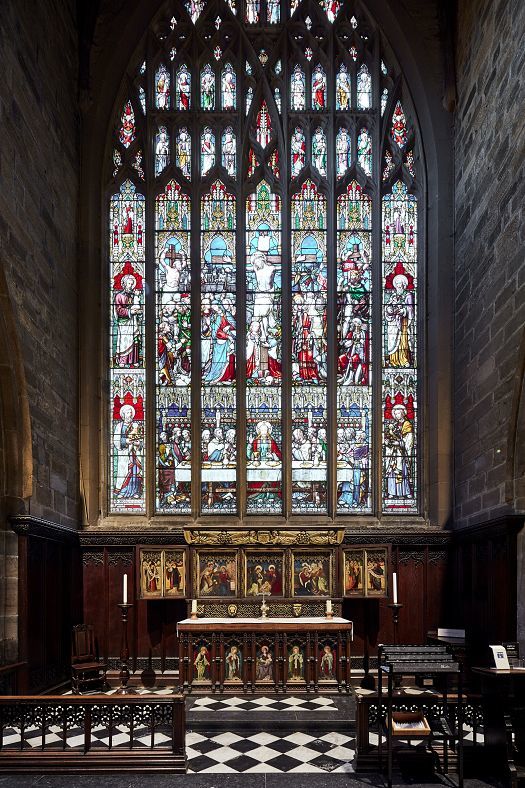 Stained glass window in Newcastle Cathedral, illuminated by ERCO LED lighting.