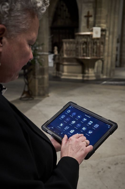 Tablet controlling ERCO LED lighting in Newcastle Cathedral. Smart lighting control for historic architecture.