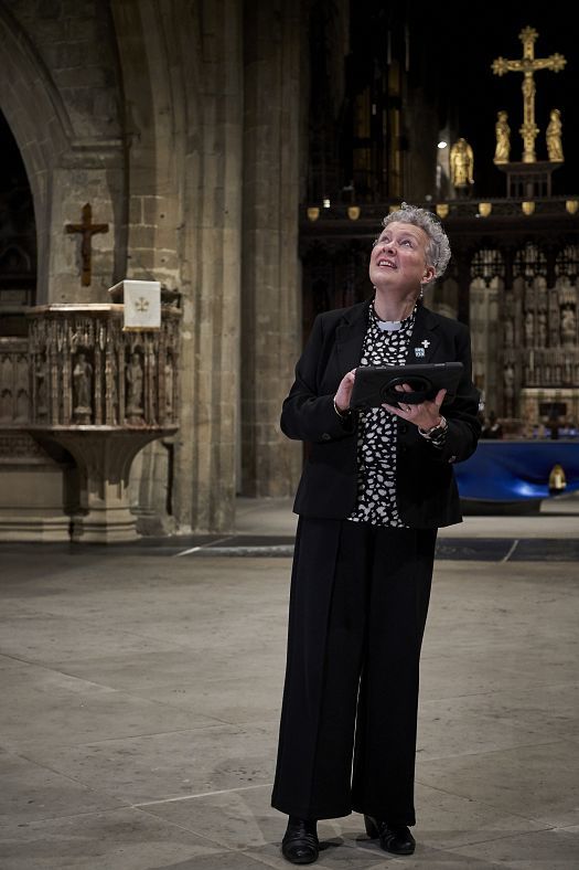 Canon Clare MacLaren in Newcastle Cathedral, viewing the new ERCO LED lighting.