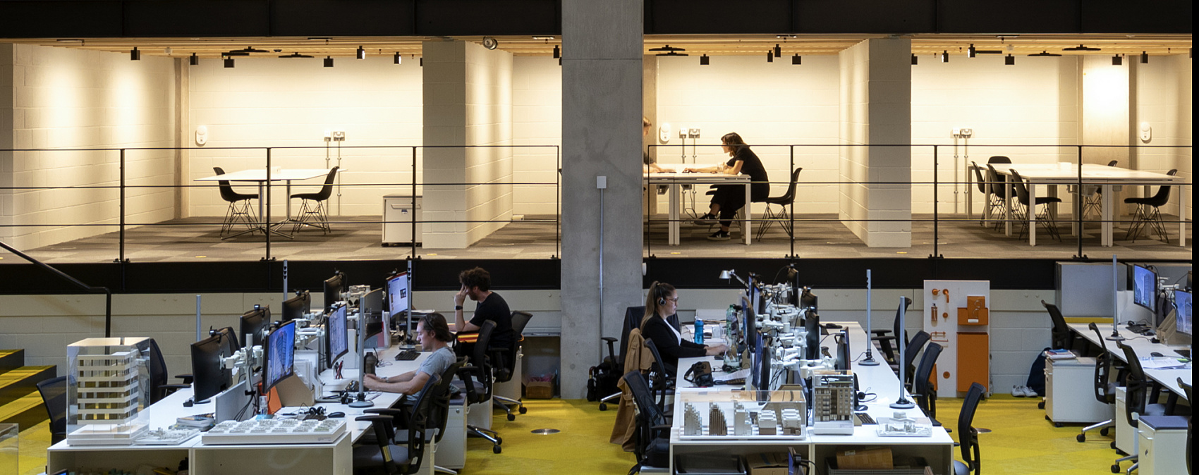 AHMM Architects office in London featuring flexible workspaces illuminated by ERCO Jilly downlights and human centric lighting.
