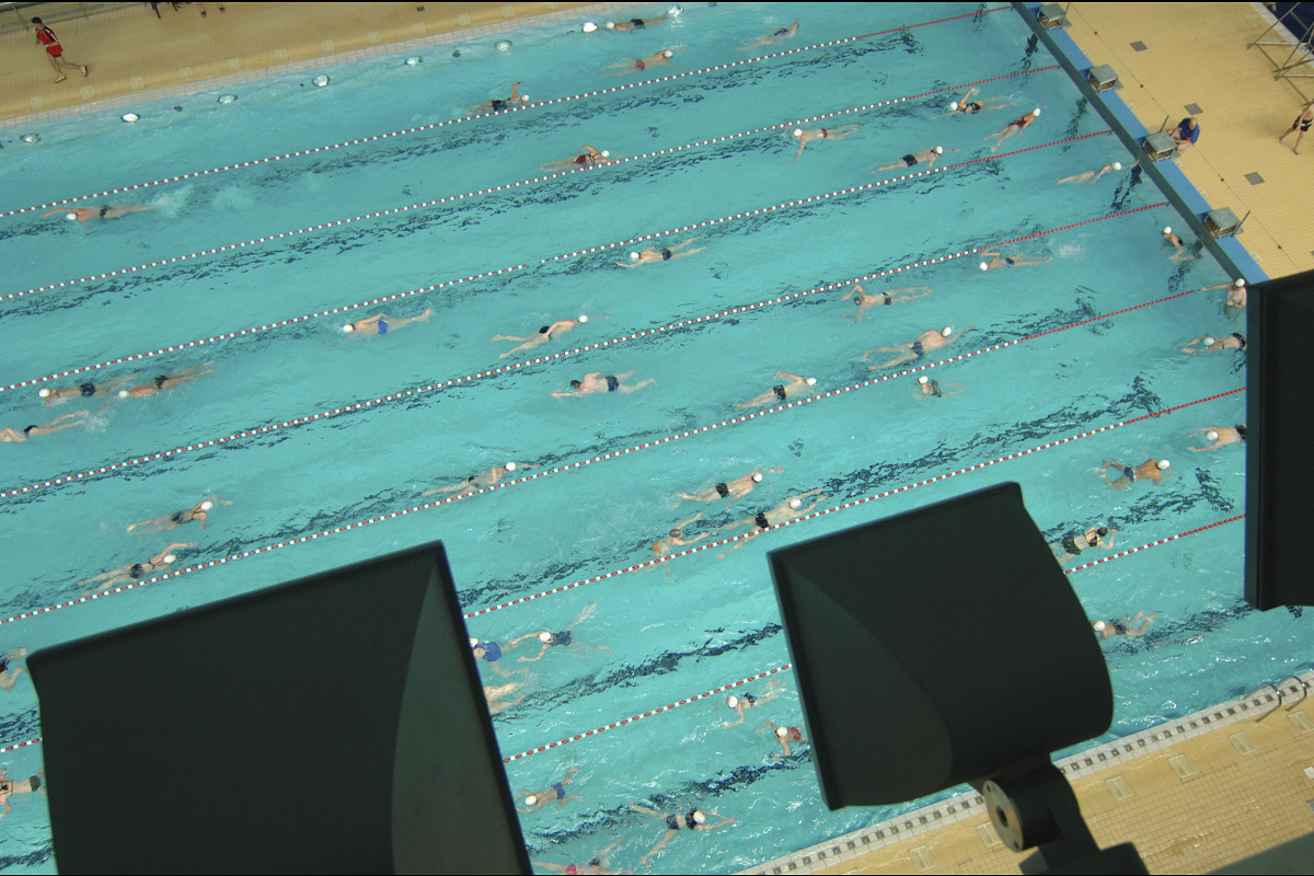 Olympia Schwimmhalle in Munich illuminated by ERCO Focalflood floodlights for competitions.