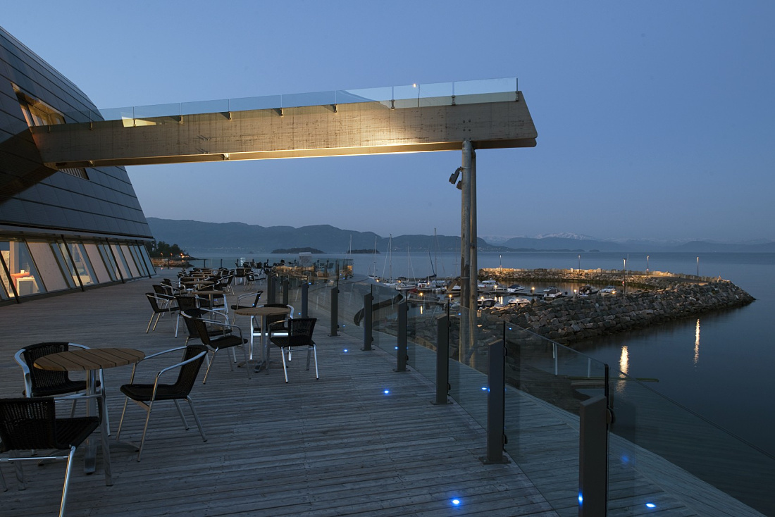 Oseana cultural centers outdoor area featuring ERCO LED lighting and harbor view.