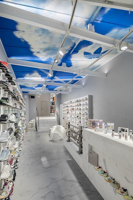 ERCO shop lighting at Overkill store, Cologne: sneakers and art displayed with wallwashing and accent lighting.