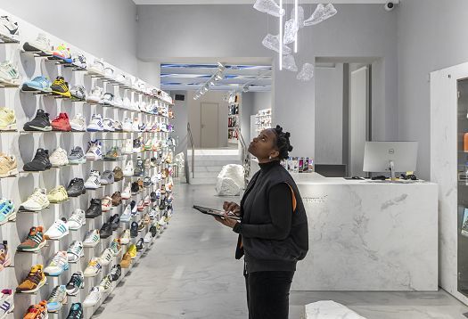 ERCO shop lighting at Overkill store, Cologne: Sneakers and art displayed with wallwashing and accent lighting.