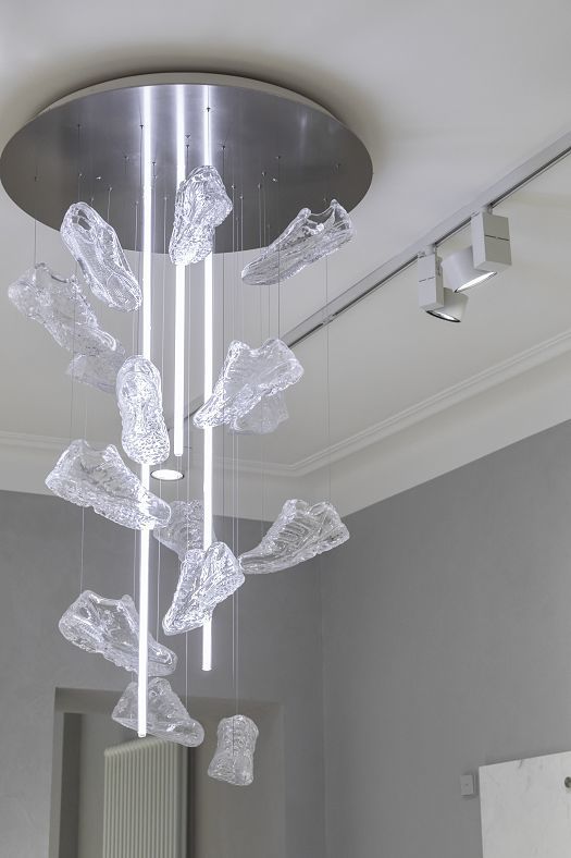 Sneaker chandelier in Overkill store, Cologne, illuminated by ERCO LED spotlights.