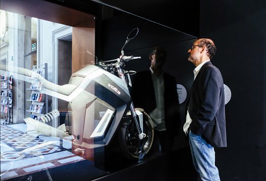 Volta motorcycle exhibit at Palau Robert, Barcelona, illuminated by ERCO spotlights.
