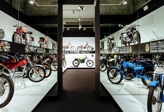 Motorcycle exhibition at Palau Robert, Barcelona, illuminated by ERCO spotlights and tracks.