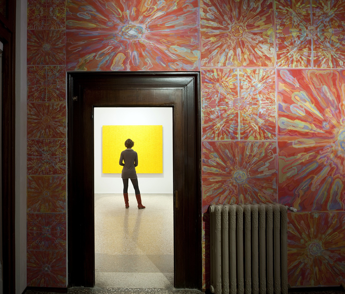 Visitor views art in Palazzo Bembo, illuminated by ERCO LED spotlights.