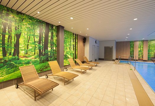 Parkbad Volksdorf pool area with ERCO Compact downlights and loungers, designed by bs2architekten.